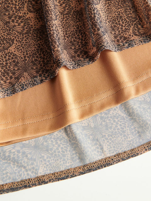 Close-up of a fabric with leopard print and beige trim on a white background