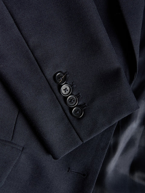 Close-up of a dark blue blazer with buttons on a blurred background