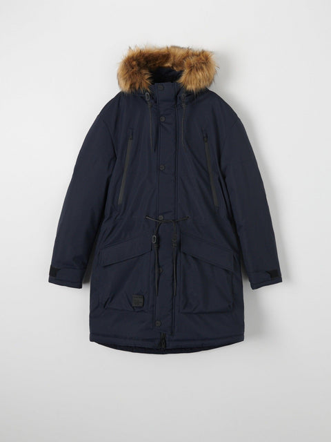 Navy parka coat with fur hood on a light gray background