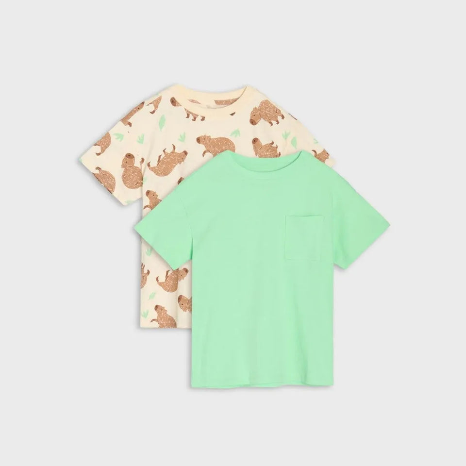 Two children's short-sleeve pocket T-shirts shown on a light gray background. The front shirt is mint green, and the back shirt is cream with a brown animal print.