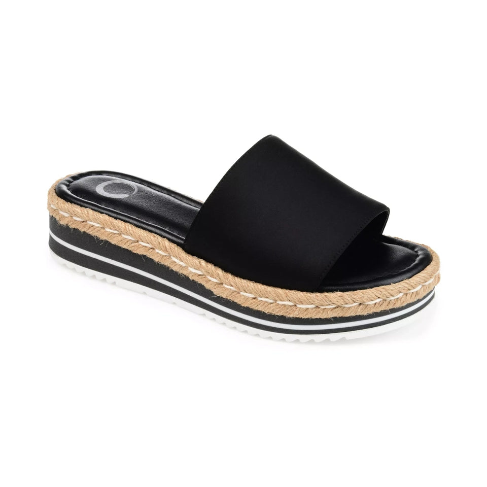 A single black platform slide sandal with a braided jute espadrille-style midsole and a white outsole, shown from a three-quarters angle on a white background.