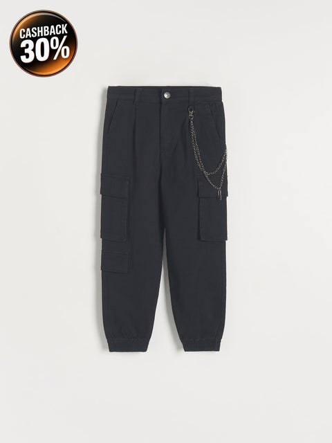 Black cargo pants with chain detail on a white background