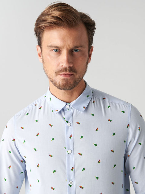 Man wearing a light blue shirt with small colorful patterns against a plain background