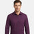 A man wearing a long-sleeve button-down shirt in a solid deep purple color, shown from the chest up against a light gray studio background.