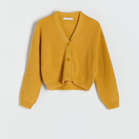 Yellow knitted cardigan on a light gray background