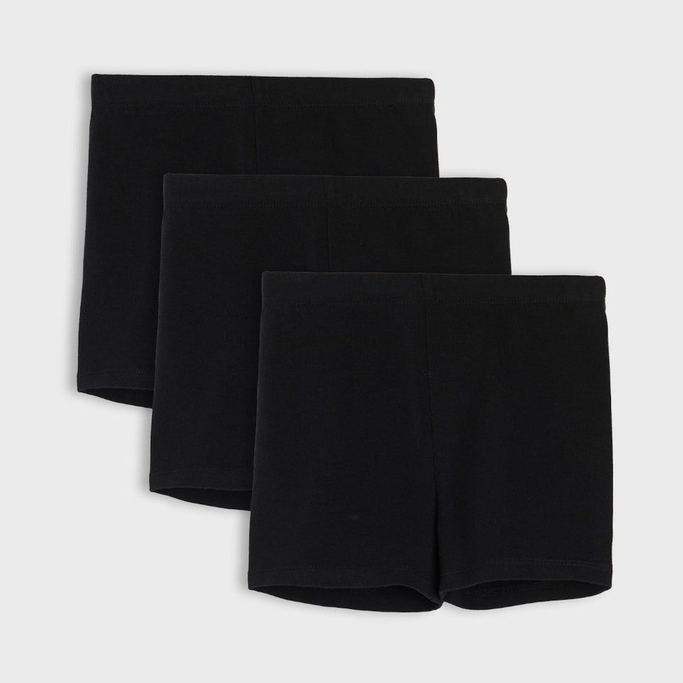 Three pairs of black shorts stacked diagonally on a light gray background.
