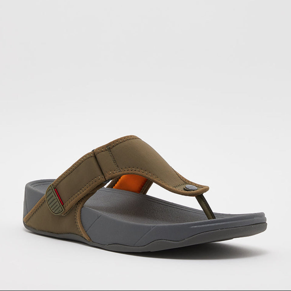 A single thong sandal with an olive green upper strap and footbed, a dark gray sole, and a small orange accent on the inner side, shown against a plain light gray background.