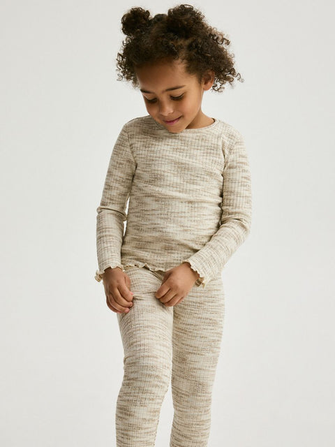 Child wearing a beige checkered outfit on a white background