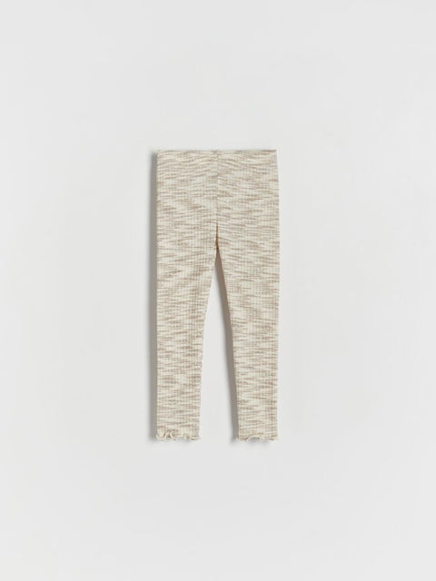 Light-colored leggings with a subtle pattern on a white background