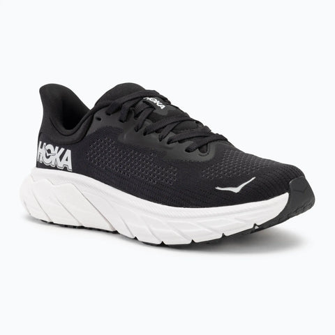 Black running shoe with white sole on a white background