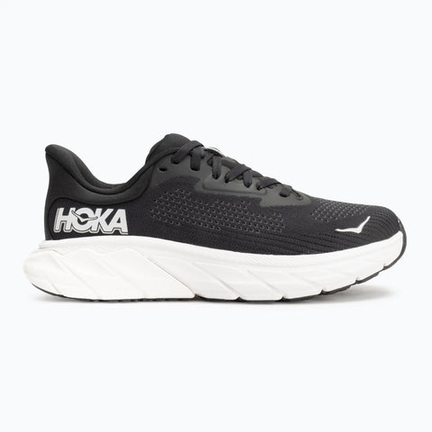 Black running shoe with white sole on a white background