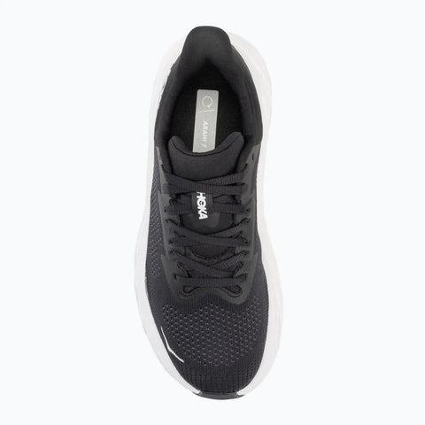 Black running shoe with white sole on a white background