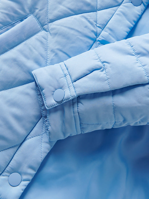Close-up of a light blue quilted jacket with button details