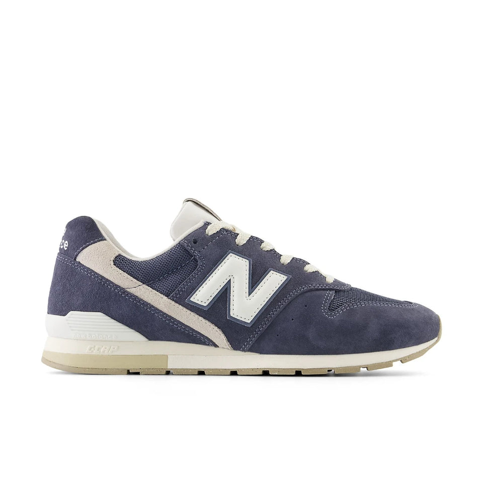 Navy blue sneaker with white accents on a white background