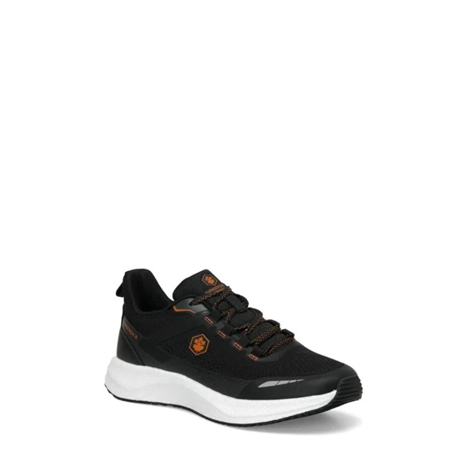 A black athletic sneaker with orange accents and a thick white midsole, shown from a side profile on a white background.