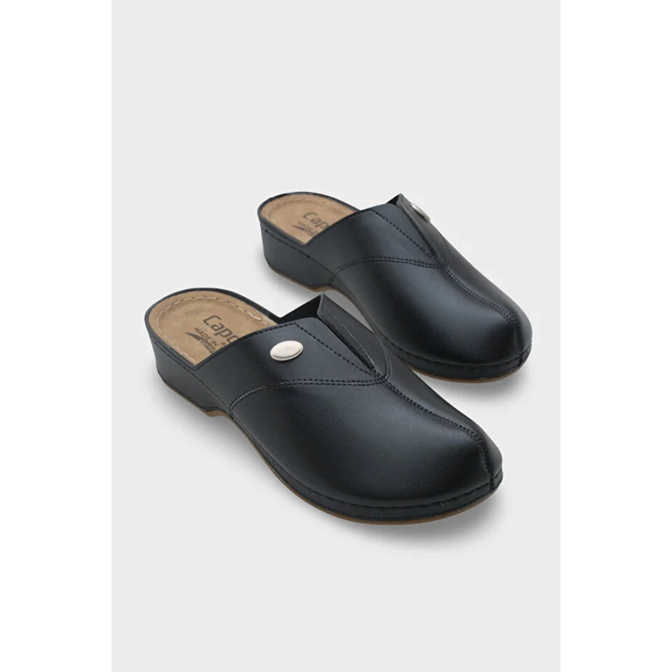 A pair of black leather clogs with a small silver button detail on the front, displayed on a light gray background.