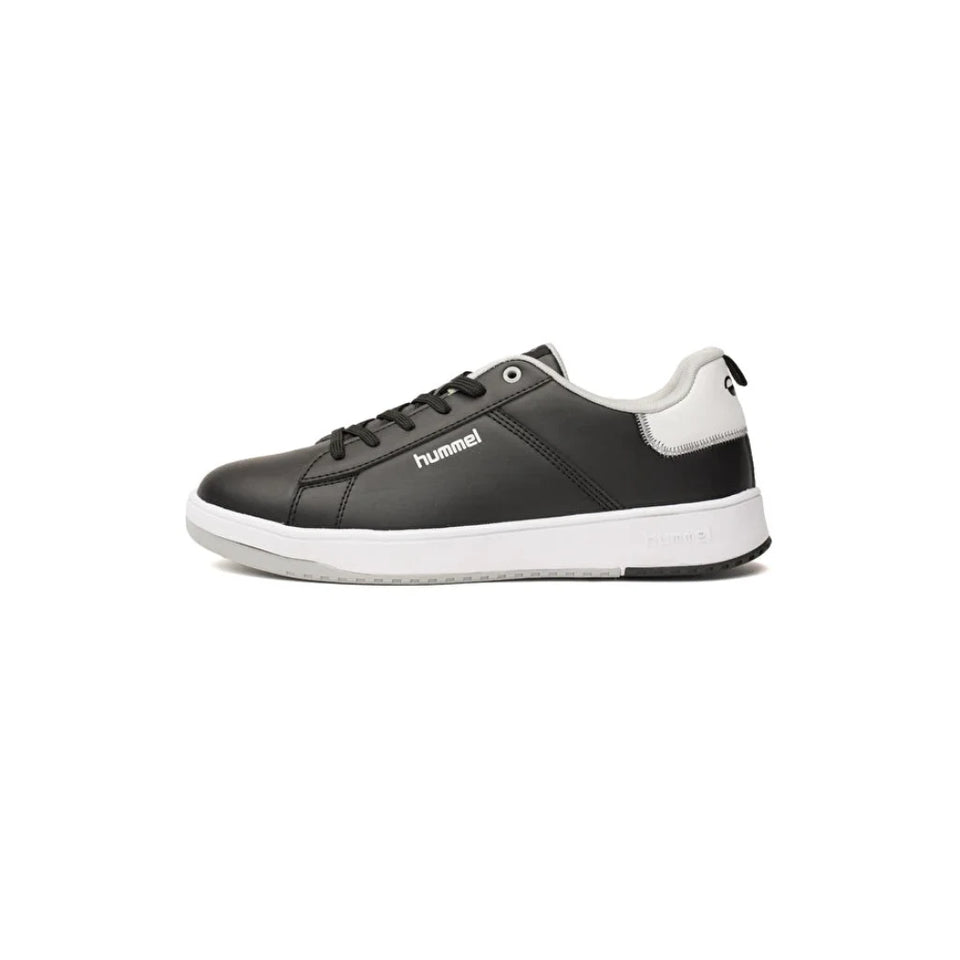 A black and white low-top sneaker by Hummel, shown in a side profile view against a plain white background.