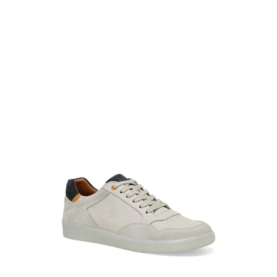A low-top sneaker in off-white leather with a black heel tab and a small orange accent on the tongue, shown against a plain white background.