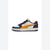 A Puma low-top sneaker in navy blue, white, and orange, shown from the side profile on a white background.