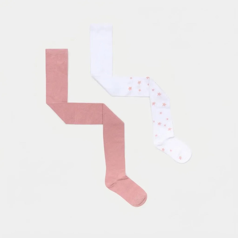 Two children's tights laid flat on a light gray background: one solid dusty pink and one white with small pink star prints.