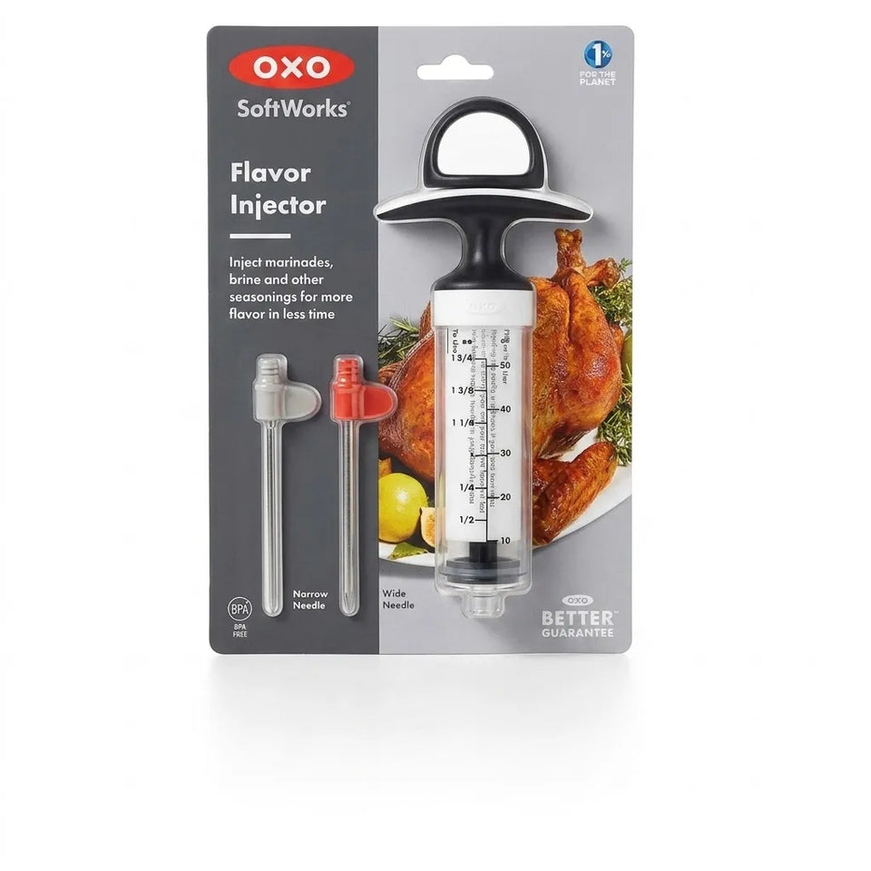 OXO SoftWorks Flavor Injector in its retail blister packaging, showing the clear syringe-style tool with black and silver components alongside two interchangeable needles.