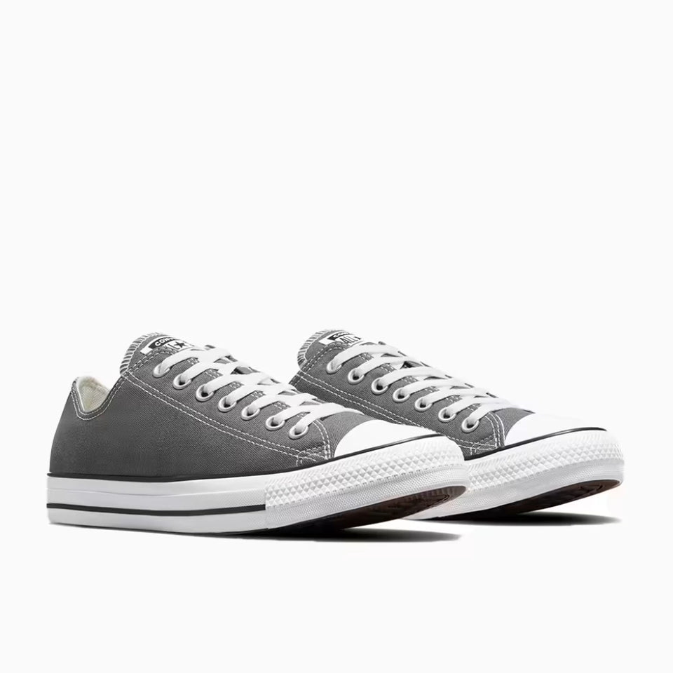 Gray sneakers with white laces on a white background