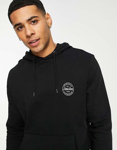 Person wearing a black hoodie with a logo on a white background