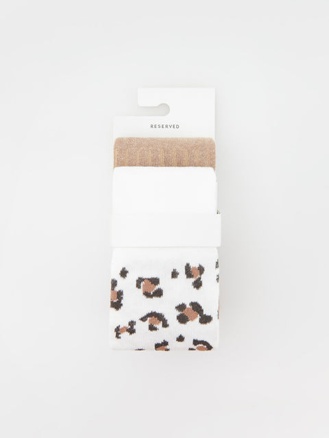 Packaged towel with leopard print design on a white background