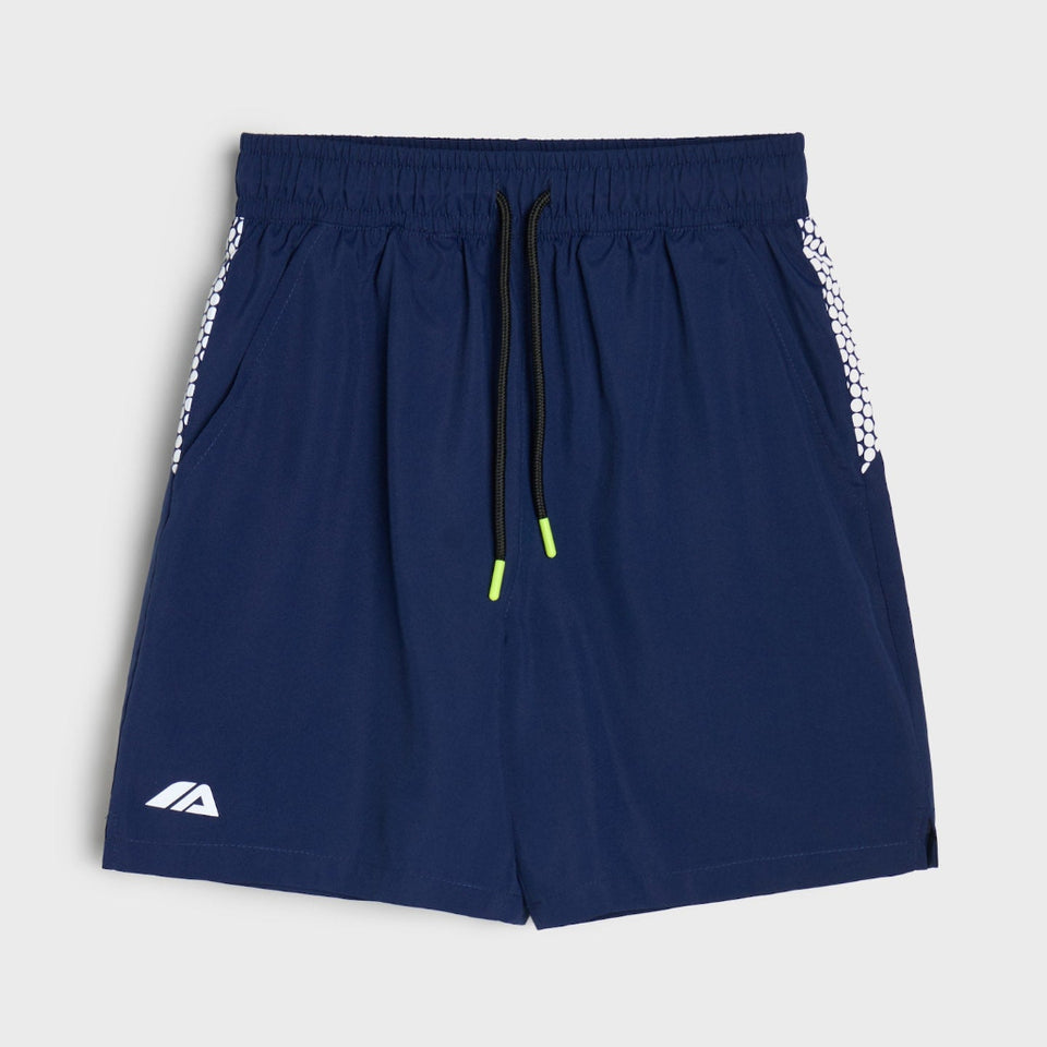 Navy blue athletic shorts with a white patterned side stripe, a black drawstring with neon green tips, and a white logo on the lower left leg, shown against a light gray background.