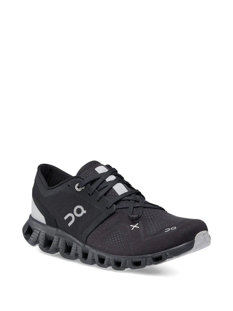 Black running shoe with white accents on a white background