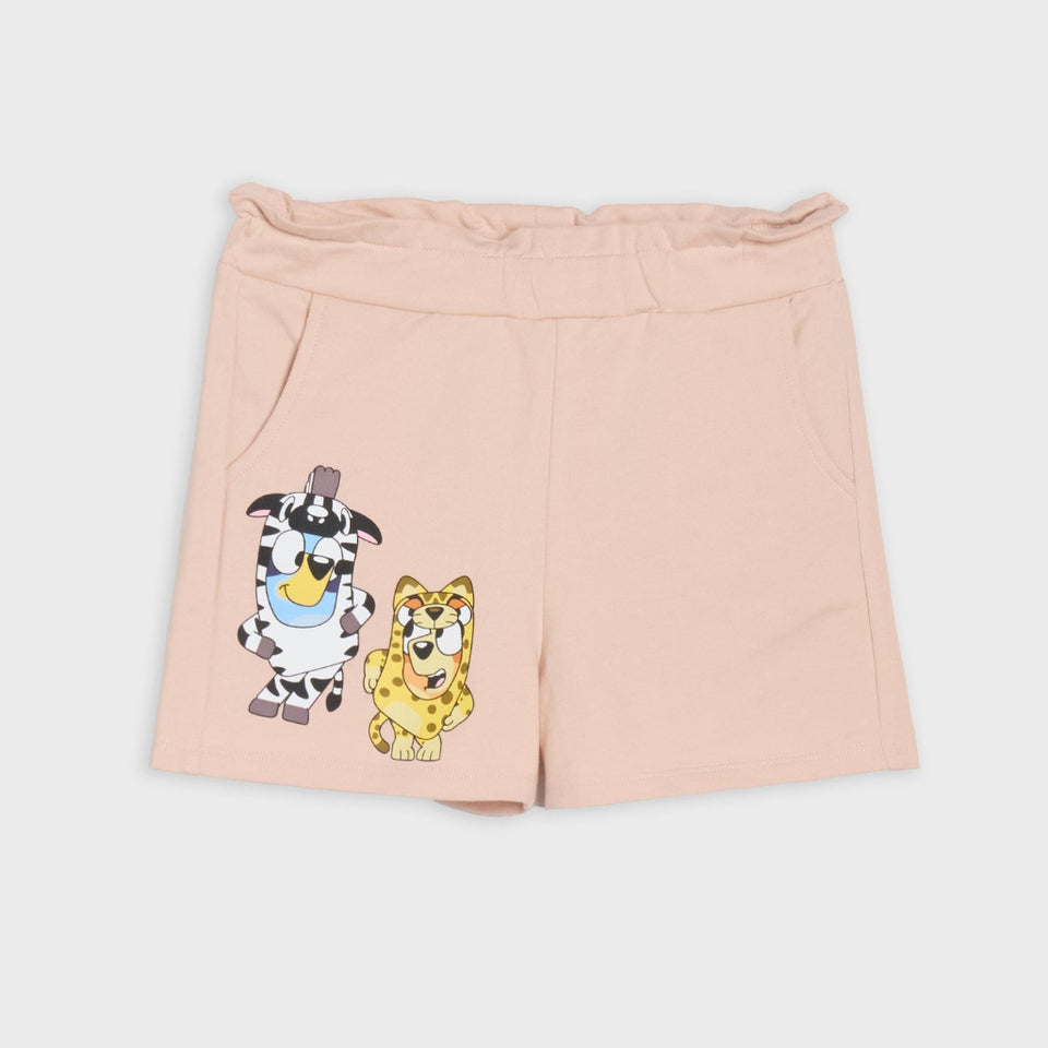 Light pink shorts with a cartoon cow and cat graphic on the left leg, displayed flat against a light gray background.