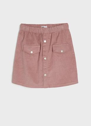 Pink skirt with button details on a light gray background