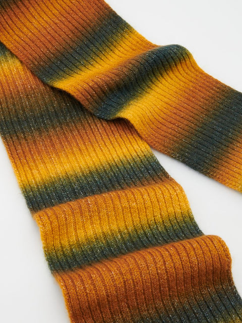 Close-up of a striped sock with orange and green colors on a white background