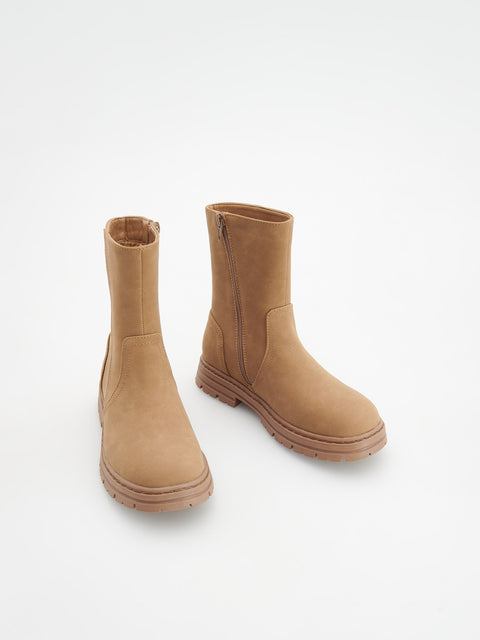 Pair of tan boots on a white background