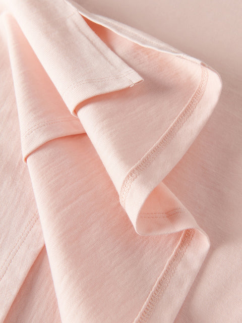 Close-up of light pink fabric with a soft texture