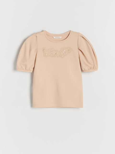 Beige dress with puff sleeves on a light gray background