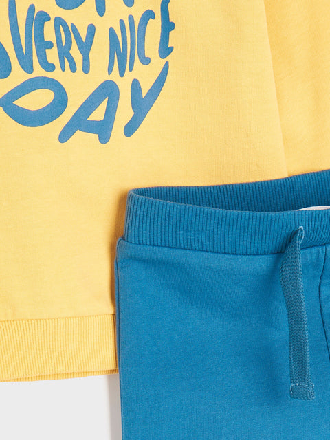 Yellow sweatshirt with blue text and blue pants on a white background