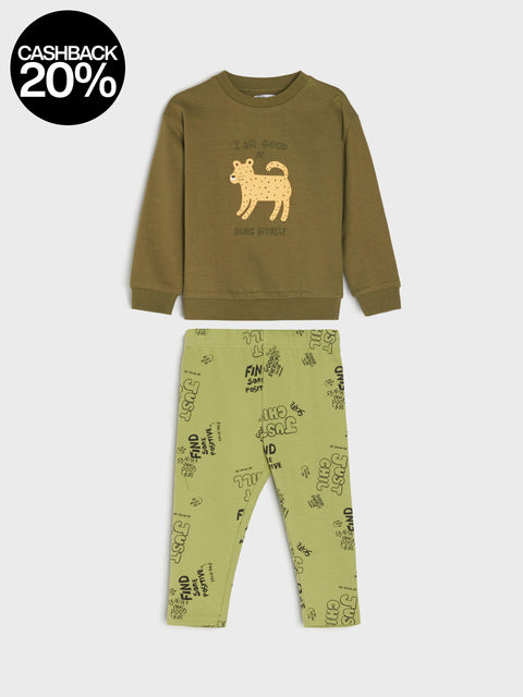 Children's green pajama set with a printed design on a white background