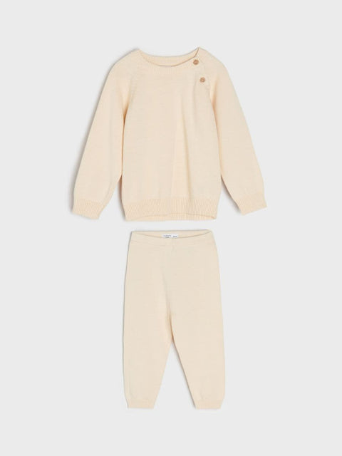 Beige pajama set with long-sleeve top and pants on a white background