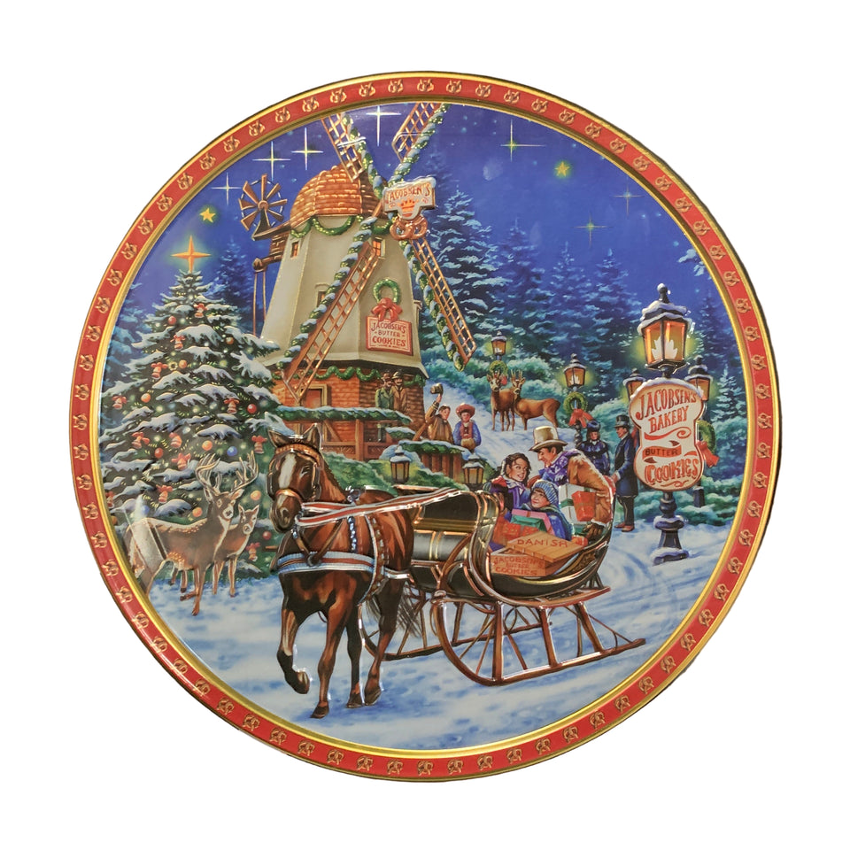 Decorative round plate with festive design on a tiled floor.