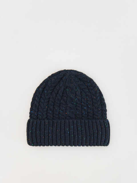 Navy blue knitted beanie on a light gray background