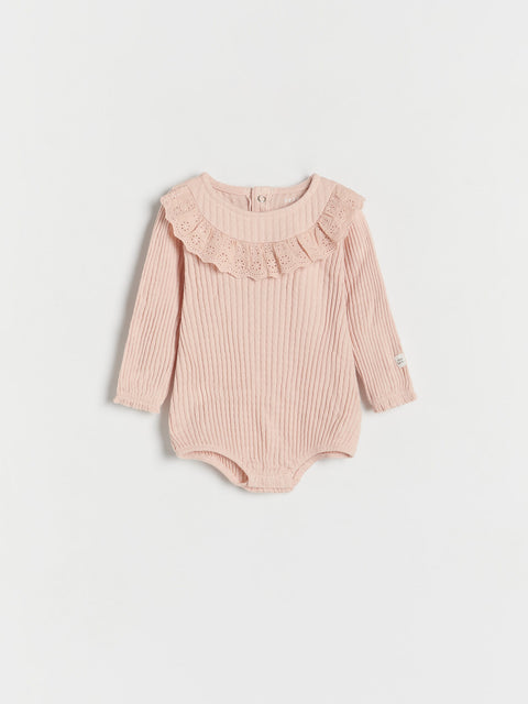 Pink baby bodysuit with ruffled collar on a light gray background