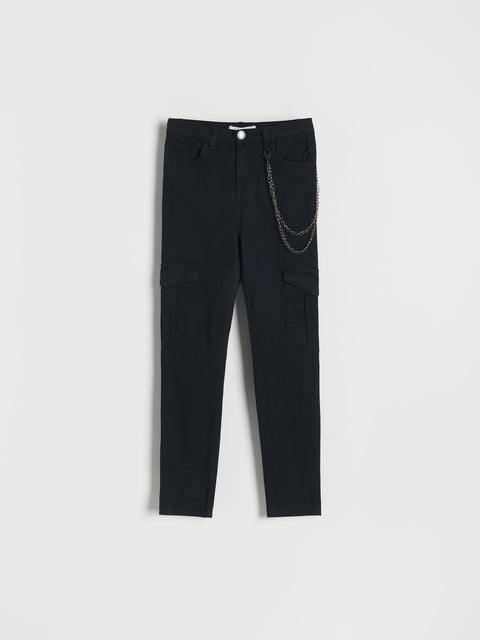 Black pants with chain detail on a light gray background