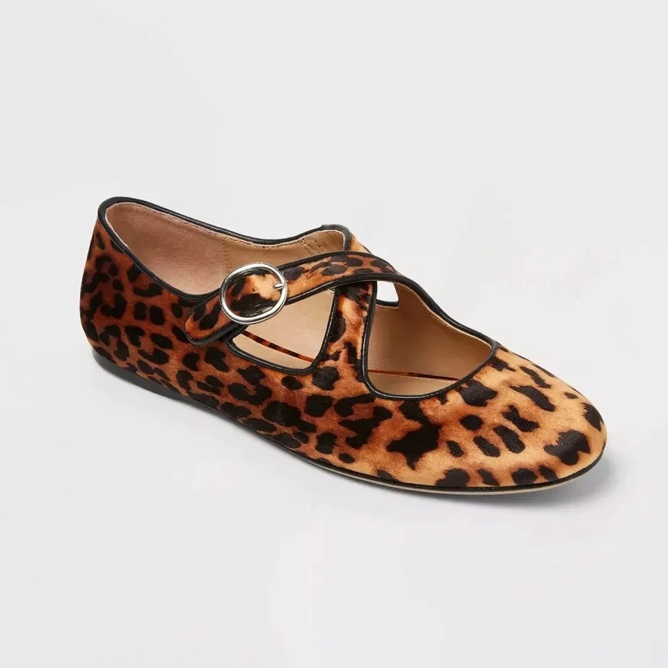 Leopard print flat shoe with a round toe and thin strap on a light gray background