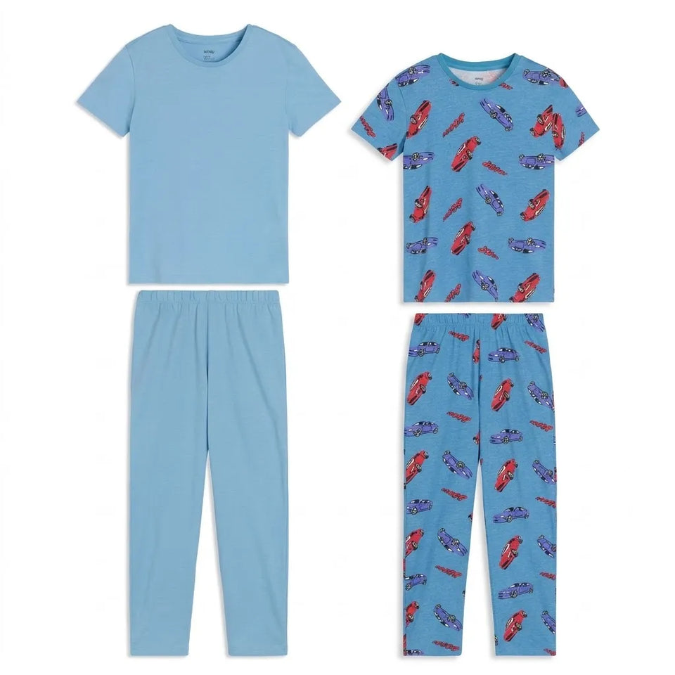 A children's two-piece pajama set shown in two colorways: one solid light blue set and one light blue set with a red and purple car pattern. Both the short-sleeve top and matching pants are displayed flat against a white background.