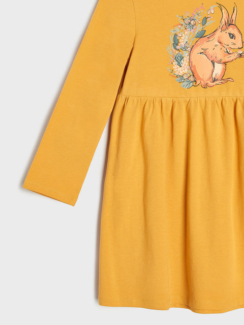 Yellow dress with a squirrel design on a white background