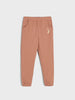 Brown sweatpants with a small embroidered design on a light gray background