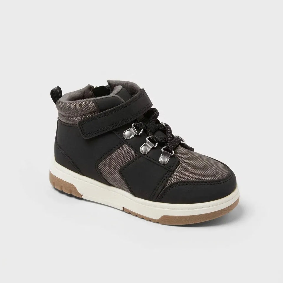 Black and gray high-top sneaker with brown sole on a light gray background