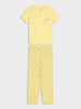 A two-piece children's pajama set consisting of a short-sleeve yellow t-shirt with a small unicorn graphic on the left chest and matching yellow patterned pants, displayed flat against a light gray background.
