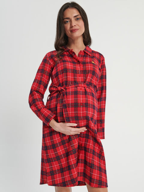 Woman wearing a red and black plaid dress on a white background